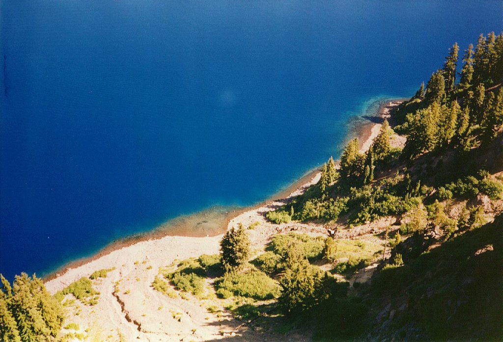 This photograph is taken looking directly down from the west side of the caldera rim just by the park Visitor Centre. You can see the incredible blue clear water and note how quickly the depth (and colour) increase from the rim.