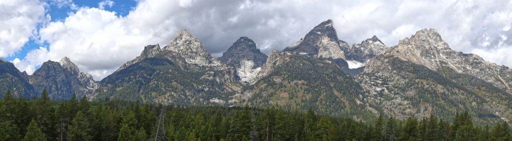 The jagged sawtooth of the Tetons dappled in shadow and light.