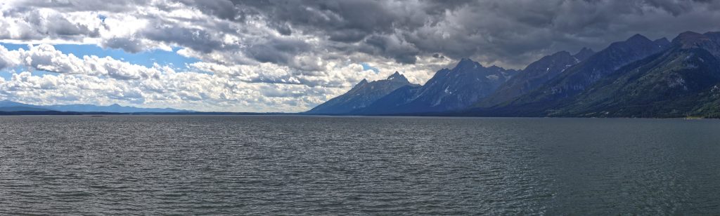 View south over Jackson Lake. The Tetons tower under dark clouds on the right (west) side of the lake.