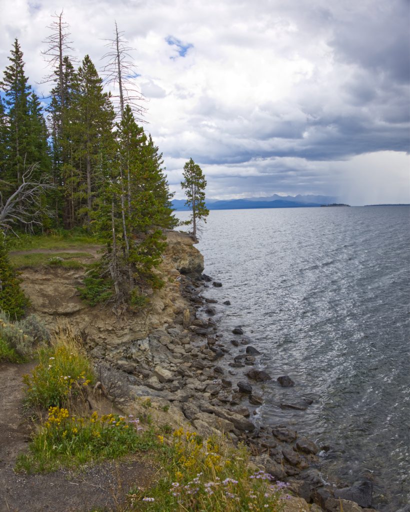 Exiting Yellowstone east entrance. You can see the rain storm chasing us on the right. This view is over Yellowstone Lake.