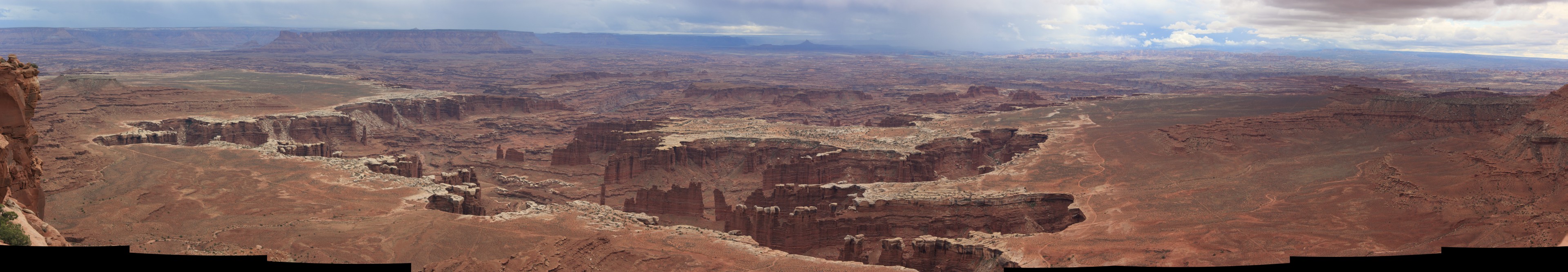 The Green River Branch. Looking northwest into some weather from the 'Island in the Sky' mesa. The Green River cannot be seen but rather this area is just a set of erosion features cut through the various steps on the Canyonlands which lead, eventually, to the Green River.