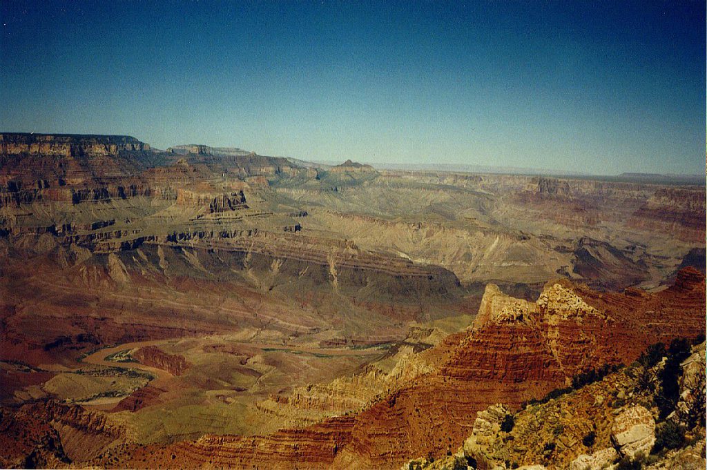 This photo, taken from the South Rim looks north-east up the canyon toward Marble Canyon (not visible). You can see the Colorado (the colour of mud) at the lower left. The green around the river is not vegetation, but rather schist (very old metamorphic rock).